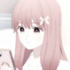 a girl with long pink hair is holding a cell phone and looking at the screen