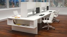 an office desk with two computer monitors and a book shelf in front of the window