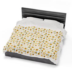 a bed with sunflowers and white sheets on it's headboard, in front of a white background