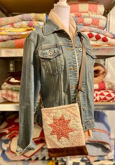 a denim jacket and purse on display in a store