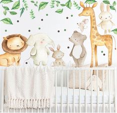 a baby's room with a crib and wall decals