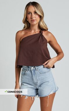 Get ready to make a statement with our Analia Top in Chocolate! This one shoulder knot detail top is the perfect addition to your casual wardrobe. Made from soft and comfortable rayon, this fashion-forward piece will turn heads wherever you go. Whether you're dressing it up for a night out or keeping it casual with jeans, the Analia Top is sure to elevate any outfit. Embrace your individuality and show off your unique style with this empowering and inclusive fashion top. Don't miss out on this m Trendy One Shoulder Top For Day Out, Trendy One-shoulder Top For Day Out, One Shoulder Cotton Top For Summer, One-shoulder Cotton Top For Summer, Cotton One Shoulder Summer Top, Summer Cotton One-shoulder Top, One Shoulder Top For Day Out, Casual Tops With Knot Detail For Spring, Chic Spring Tops With Knot Detail