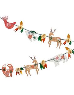 christmas garland with deers and birds hanging from it's side on a white background