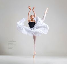 the ballerina is dressed in white and black