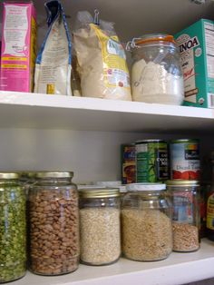 the shelves are filled with various types of food and drinks, including rice, beans, cereal, milk, and other items