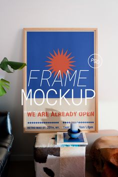 a poster with the words frame mockup on it next to a stool and plant