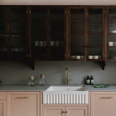 a kitchen with wooden cabinets and white counter tops, including a dishwasher in the center