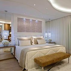 a bedroom with a large bed and white walls