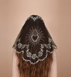 the back of a woman's head wearing a veil