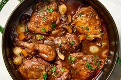 a pot filled with meat and vegetables on top of a table