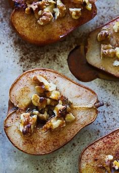 baked apples with walnuts and pecans in them on a baking sheet, ready to be eaten