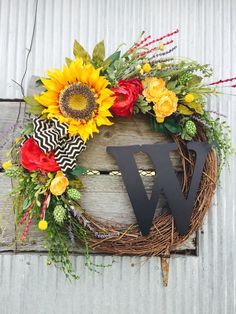 a sunflower wreath with the letter w on it