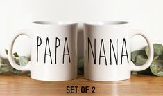 two white coffee mugs with the words papa nana and set of 2 on them