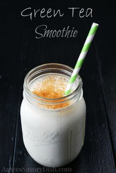 green tea smoothie in a mason jar with a striped straw