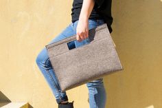 "Are you looking for an unconventional bag? This minimalist felt handbag is perfect for you! It's a stunning rectangular shaped bag with cut-out handles, stylish and comfortable at the same time. You can wear it at work or to go out, it will add a touch if style to every outfit. The handbag is soft and durable at the same time, because it's made of 100% merino wool felt. + 11.8x15.7x4\" - 30x40x10 cm + cut-out reinforced handles + double-pocket inside + zipper closure + adjustable/removable leat Felt Handbag, Felted Handbags, Felt Coasters, Gray Handbags, Minimalist Bag, Grey Bag, Top Handle Bags, Leather Label, Felt Bag