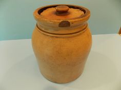 a brown jar sitting on top of a white table