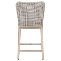 a white wicker bar stool with wooden legs