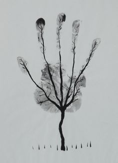 a black and white photo of a tree in the snow