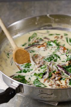 a pan filled with food and a wooden spoon