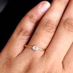 "Oval cut natural Diamond solitaire, set east-west in a dainty 14k 18k solid gold bezel setting on a minimal comfort fit band. Dazzling yet simple engagement ring. A great anniversary and Valentine's Day gift!  *  Gold: 14k / 18k Solid Gold  *  Gold Colour: Yellow / Rose / White  *  Gold Wt.: ~1.5gm (14kt) *  Gemstone: Natural Genuine Diamond *  Diamond Wt.: ~0.16-0.19 Ct  *  Color-Clarity: G-H, Vs-Si * Authenticity Check: This ring will be marked for gold and will come with EGL (or equivalent) Everyday Diamond Ring With Bezel Setting, Oval Diamond Ring With Single Diamond, Everyday Oval Ring With Single Diamond, Oval Diamond Ring With Smooth Bezel, Minimalist Oval Diamond Ring With Bezel Setting, Dainty Oval Solitaire Diamond Ring, Oval Diamond Promise Ring With Smooth Bezel, Delicate Oval Bezel Set Ring, Delicate Oval Ring With Bezel Setting