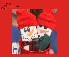 two snowmen are sitting in a red cup