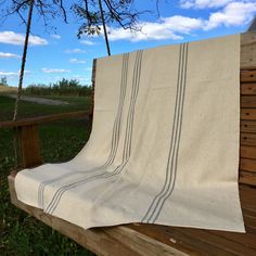 a blanket sitting on top of a wooden bench