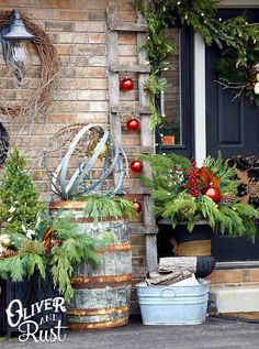 two buckets filled with christmas decorations next to a door