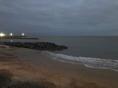 the beach is empty at night and there are no people on it or in the water