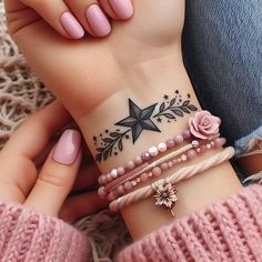 two girls with pink nails and bracelets on their wrist, one is holding the other's hand