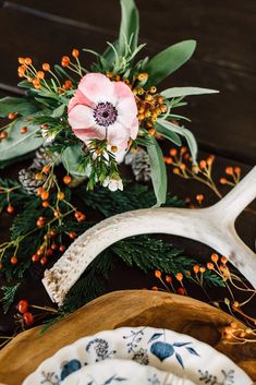 the antler head is next to some flowers and other decorations