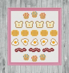 a cross stitch pattern with eggs, sausages and other foods on it in a pink frame