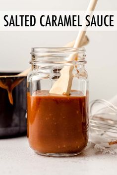 salted caramel sauce in a glass jar with a wooden spoon