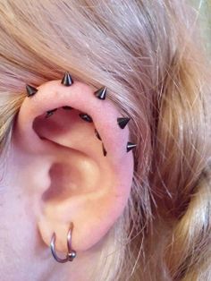 a woman with some piercings on her ear