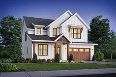 a white house with two story windows and brown shutters on the front door is lit up at night