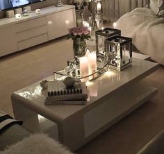 a living room filled with furniture and candles