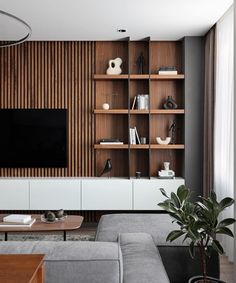 a modern living room with wood paneling and white furniture