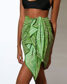 Complete your beach look with this stylish green chiffon pareo featuring a captivating eye-pattern scarf print. Perfect for layering over your swimsuit, the lightweight material offers both comfort and fashion, making it a must-have accessory for any beach or pool day.