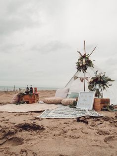 a tent set up on the beach for an outdoor ceremony