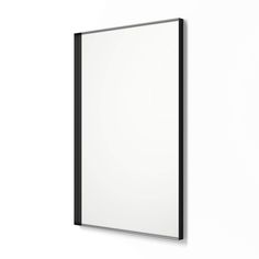 a white wall with a black frame hanging on it's side next to a mirror