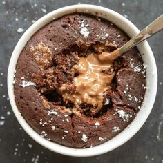 a chocolate dessert in a white bowl with a spoon