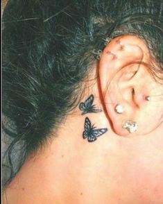 a woman's ear with butterflies on it