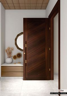 a wooden door in a white room with vases and mirror on the side table