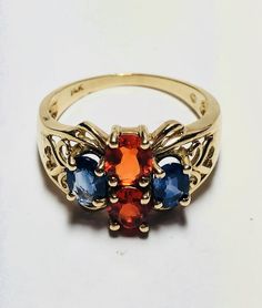 Beautiful Vintage 14k Yellow Gold Natural Sapphire and Orange Opal Ring 100% Genuine Sapphires and Orange Opals Beautiful and clean genuine Sapphire and Orange Opal Sapphire(s) 1.00CT Orange Opal(s) 1.00CT Total ring weight: 4.4GR 14K Yellow Gold Ring sizing available Free of Charge For more information regarding this item feel free to reach me so I can accommodate your needs. Thank you Gold Multi-stone Oval Sapphire Ring, Gold Multi-stone Sapphire Ring With Oval Shape, Gold Oval Sapphire Ring With Multi-stones, Elegant Multi-stone Gemstones In 14k Gold, 14k Yellow Gold Multi-stone Gemstones, Multi-stone 14k Gold Gemstones For Anniversary, 14k Gold Multi-stone Gemstones For Anniversary, 14k Gold Gemstones For Anniversary, Classic Multi-stone Birthstone Ring