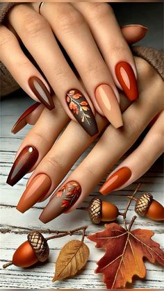 Embrace the beauty of autumn with this stylish fall nail set, featuring warm hues like burnt orange, mustard yellow, and chocolate brown. The nails boast a mix of glossy ombré and matte finishes, with subtle gold accents adding a touch of elegance. Intricate leaf and acorn designs complete the seasonal look, making this set perfect for cozy vibes and keeping up with the latest fall nail trends. Elevate your autumn style with these beautifully crafted autumn nails. Mustard Ombre Nails, Fall Photoshoot Nails, Nails Ideas For Thanksgiving, Nail Design For Autumn, Matte Copper Nails, Fall Color Almond Shape Nails, Thanksgiving Matte Nails, Burnt Orange Brown Nails, Acorn Nails Designs