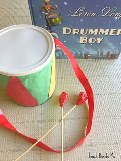 there is a drum and some candy on the table