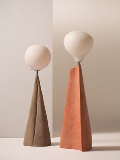 two different colored lamps sitting next to each other