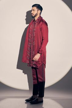 Maroon kurta with placed cutdana embroidered floral patterns. Comes with pant and dupatta.
Components: 3
Pattern: Embroidered
Type Of Work: Cutdana, Sequin
Neckline: Mandarin Collar
Sleeve Type: Full
Fabric: Satin linen, Lining: Satin
Color: Maroon
Other Details: 
Attached lining
Side pockets
Closure: Kurta: Front concealed placket
Occasion: Sangeet,Cocktail - Aza Fashions Bollywood Style Pant Set With Intricate Embroidery, Festive Bollywood Pant Set With Intricate Embroidery, Traditional Pant Set With Dupatta And Long Sleeves, Traditional Long Sleeve Pant Set With Dabka Work, Diwali Long Sleeve Pant Set With Resham Embroidery, Diwali Resham Embroidery Long Sleeve Pant Set, Traditional Long Sleeve Pant Set With Dupatta, Festive Long Sleeve Pant Set With Resham Embroidery, Semi-stitched Embroidered Pant Set For Eid