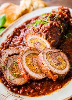 sliced meatloaf with sauce and garnish on a white plate, ready to be eaten