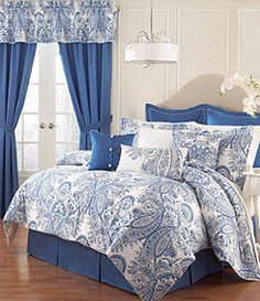 a blue and white bed in a bedroom