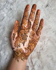 the hand is decorated with henna designs on it